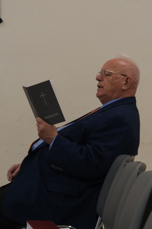 Dino Roussos, minister for the Glyfada Church of Christ, sings from a Greek hymnal.