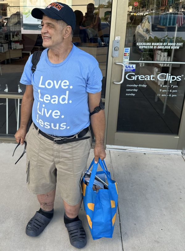 Maurice Costabile poses for a picture after getting a haircut and a shave at Great Clips.