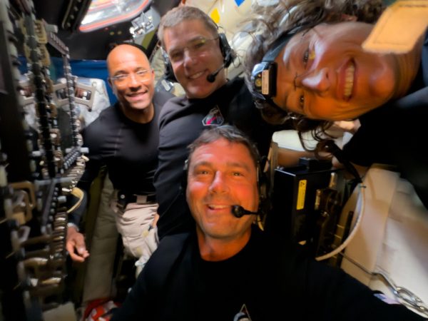 Midway through their lunar observation period, the Artemis II crew members — Reid Wiseman, Victor Glover, Christina Koch, and Jeremy Hansen — pause to turn the camera around for a selfie inside the Orion spacecraft.