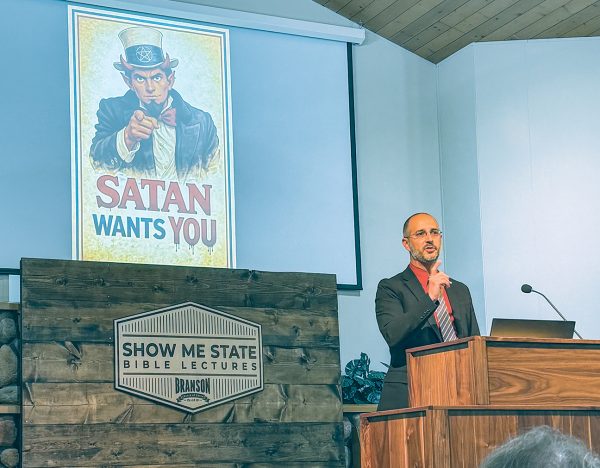 Brent Green shows an artificial intelligence-generated image during his sermon at the Show Me State Bible Lectures. A friend heard the title of Green's sermon, "Satan Wants You," and said it reminded him of armed forces recruiting posters featuring Uncle Sam, which prompted Green to have another friend create the AI image.