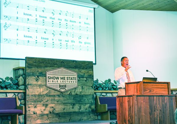 Participants in the Show Me State Bible Lectures sing hymns, including "I Know That My Redeemer Lives," before the Saturday night sermons.