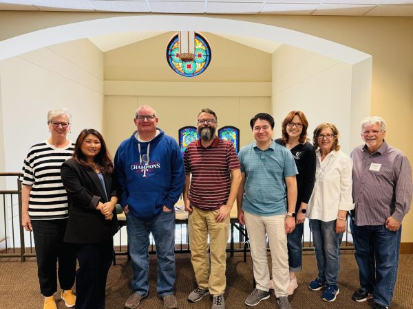 Calvin Cockrell, fifth from left, poses for a photo with other Christian Chronicle staff members during a meeting in Dallas. Also pictured, from left, are Cheryl Mann Bacon, Sawmi Sektak, Bobby Ross Jr., Erik Tryggestad, Connie Penick, Melinda Wilson and Alan Phillips.
