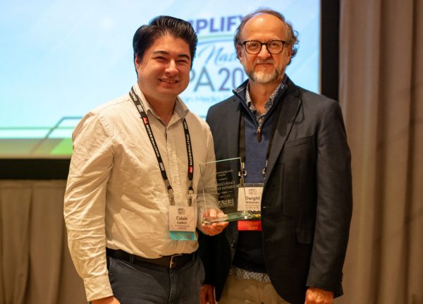 Calvin Cockrell, left, receives the 2026 Emerging Journalist Award from Dwight Widaman, president of the Evangelical Press Association. The honor was announced at EPA's recent national convention in Franklin, Tenn., south of Nashville.
