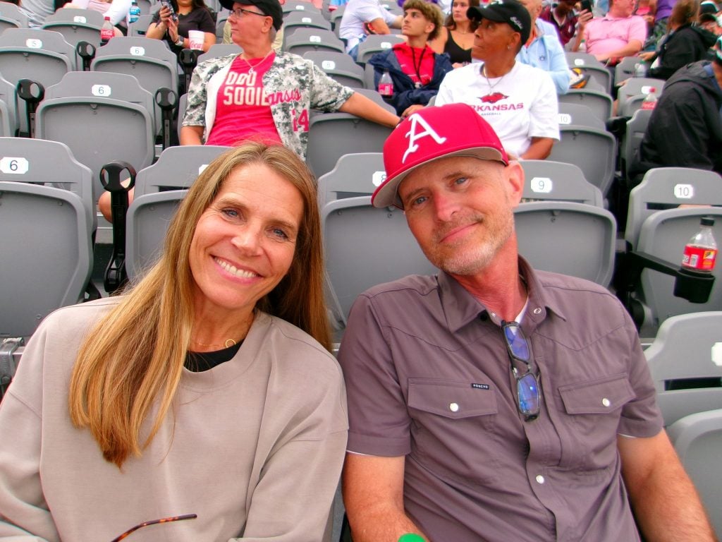 Chris McCurley and his wife, Libby, pose for a picture during a University of Arkansas baseball game.