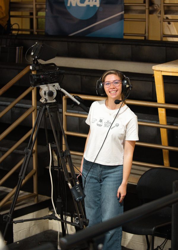 Kenzie James works as a camera operator during a basketball game at Harding University in Searcy, Ark. 