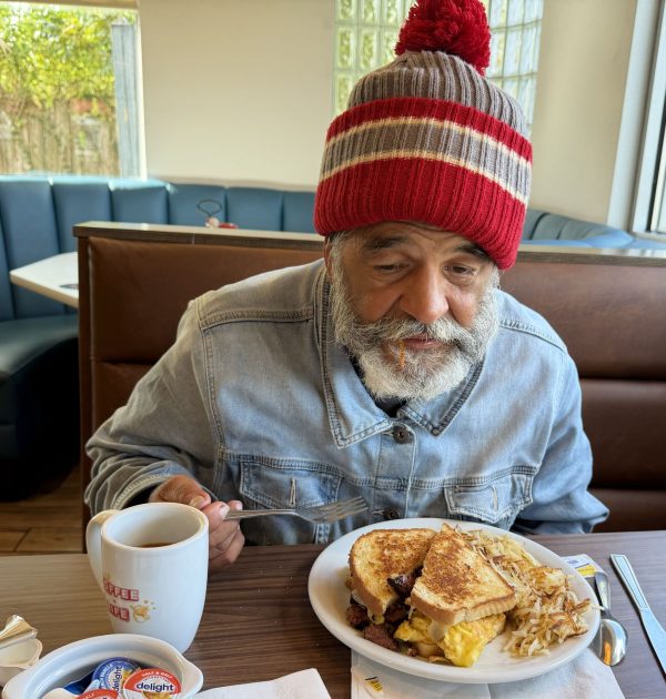 Maurice Costabile enjoys a meal with a church member.