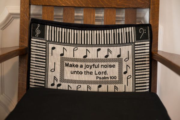 A seat cushion at the Owen Chapel church is embroidered with the words of Psalm 100 “Make a joyful noise unto the Lord.”
