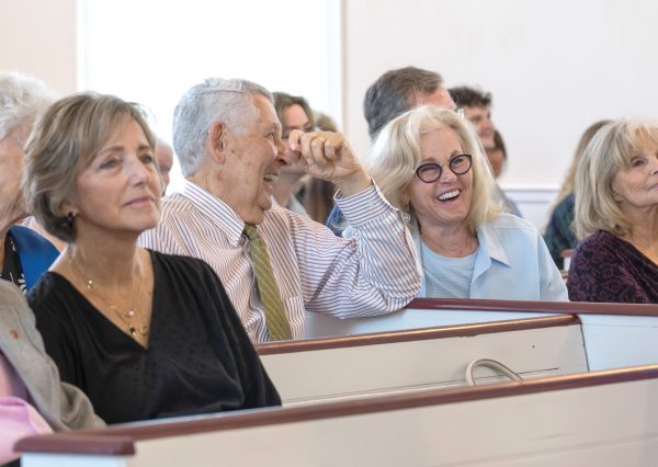 Members of the Owen Chapel Church of Christ laugh during a Sunday service.
