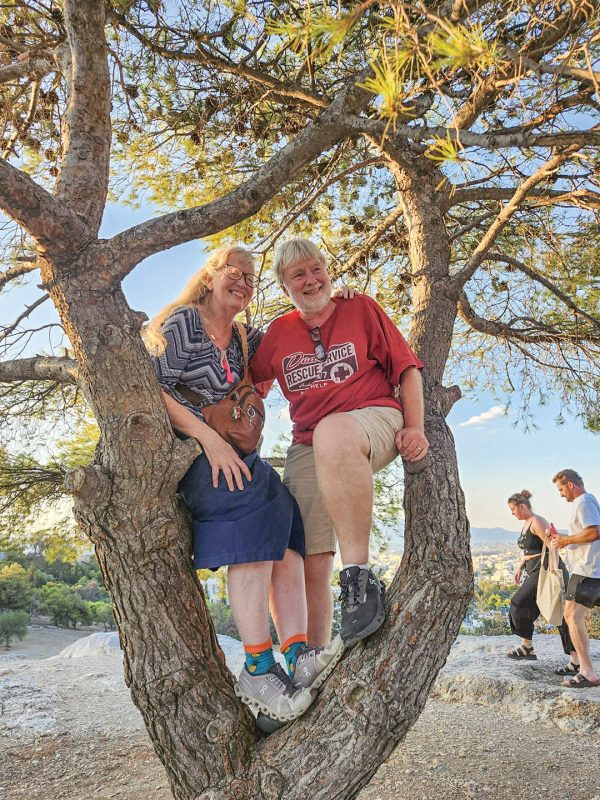Missionaries Tricia and Keith Young sit in a tree as they explore Athens with friends.
