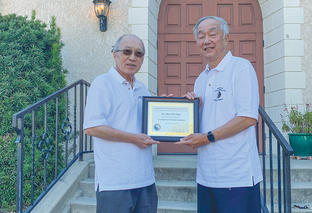 Allen Wai Jang, right, receives American Tai Chi & Qigong Association Master status from Master Chung Wu from the Maryland Institute for Tai Chi Arts.