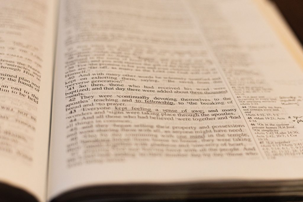 A Bible lay open to Acts 2, where thousands were baptized and added to the church on the Day of Pentecost.
