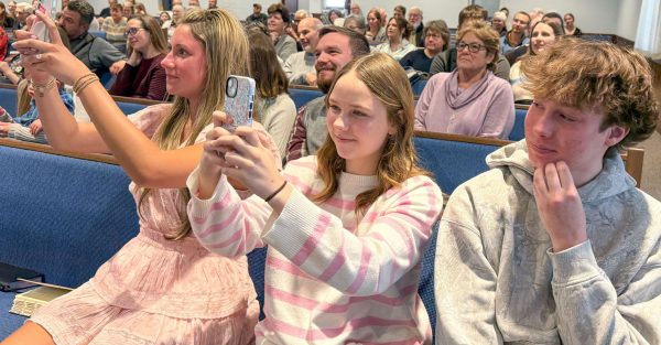 Visitors take photos during the baptism of Ariana Boyd at the Cornerstone Church of Christ in Pottstown, Pa.