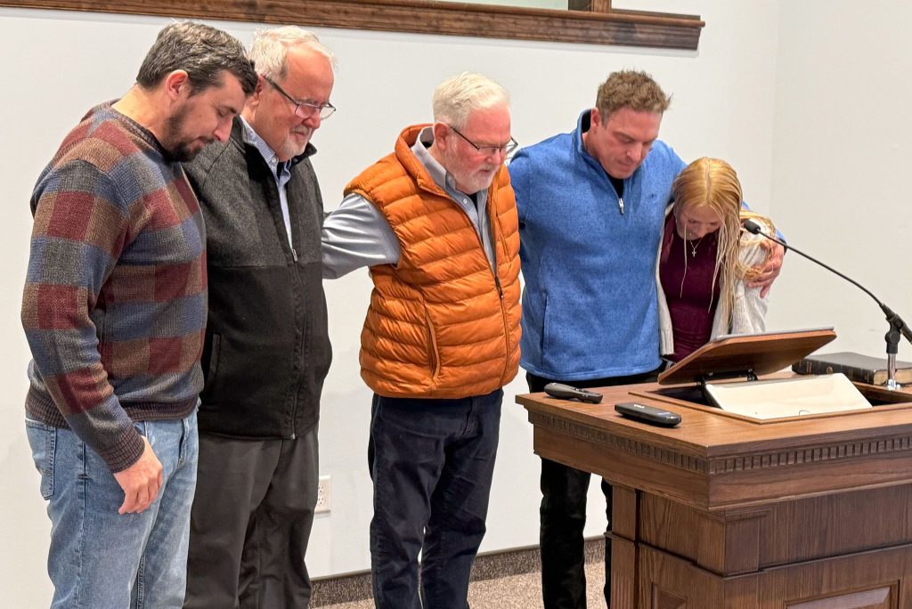 Elders Josh Dove, Jeff Custer and Rick Elam and member Pedro Delgado pray for Ariana Boyd after her baptism at the Cornerstone Church of Christ in Pottstown, Pa.
