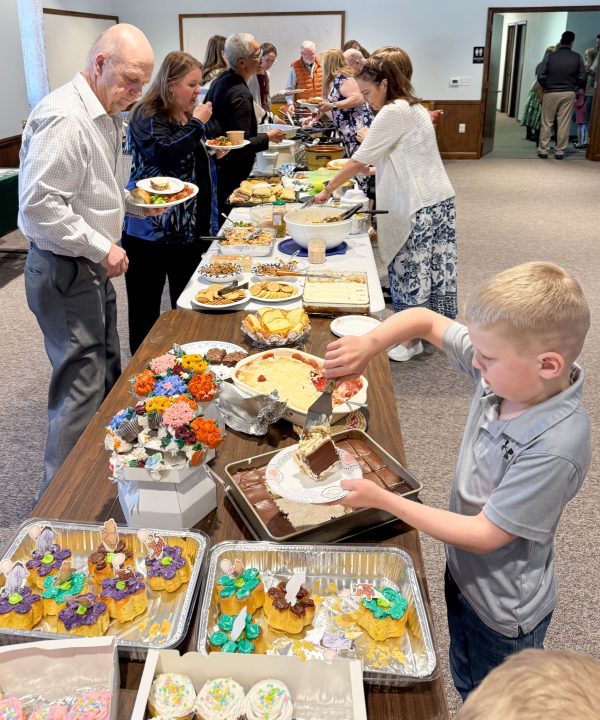 John Eli Richard, right, indulges in the dessert offerings at a fellowship meal of the Cornerstone Church of Christ in Pottstown, Pa.