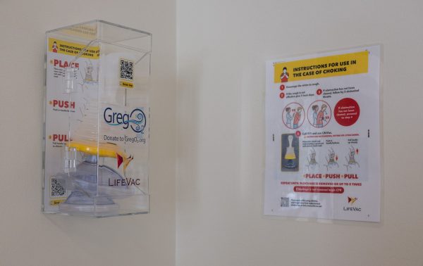 A GregO2 device used in instances of choking and a manual on how to use it rests on the wall in the fellowship hall.