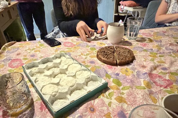 At a missionary's home in Birmingham, American and Iranian Christians enjoy desserts including a box of gaz (nougat filled with roasted pistachios) as they play hokm, an Iranian card game similar to spades.