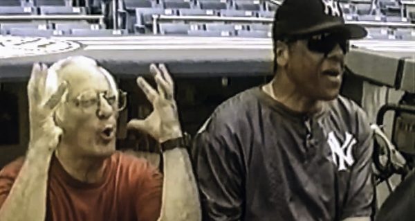 Duilio Costabile, left, shares a laugh with Yankees first base coach José Cardenal in the 2007 documentary “Duilio: Home Movies From The Bronx.” (Video still via YouTube. Warning: Video contains R-rated language)