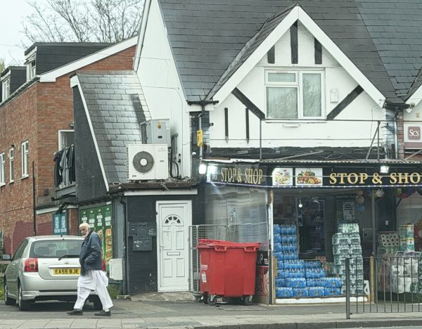 A Muslim man walks through a neighborhood in Birmingham, England.